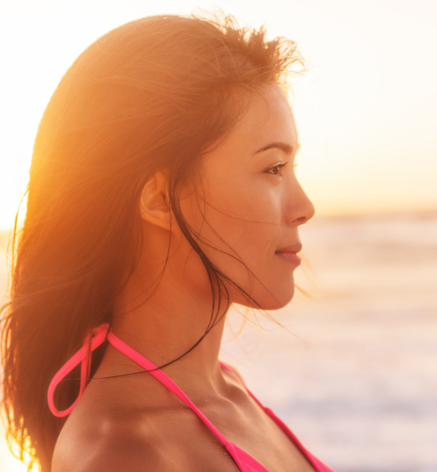 woman on the beach during sunset