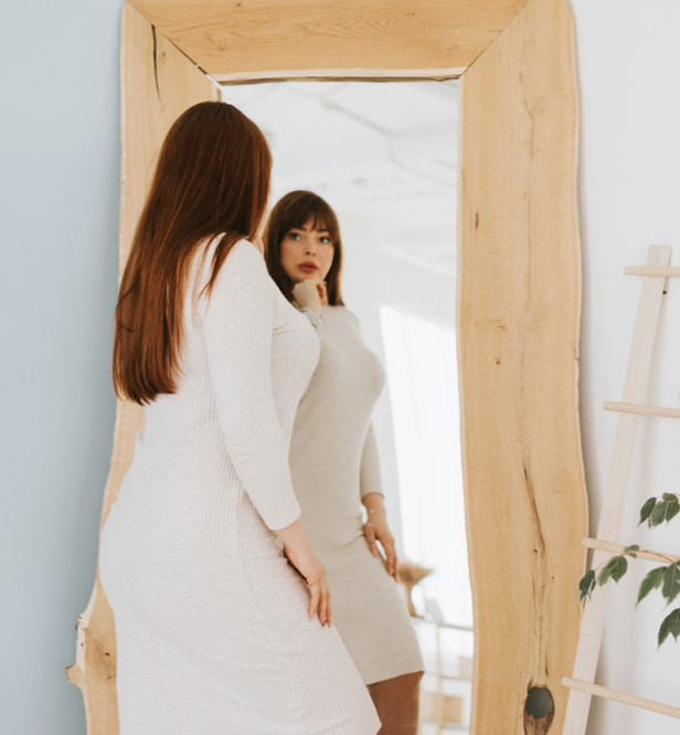woman looking in the mirror