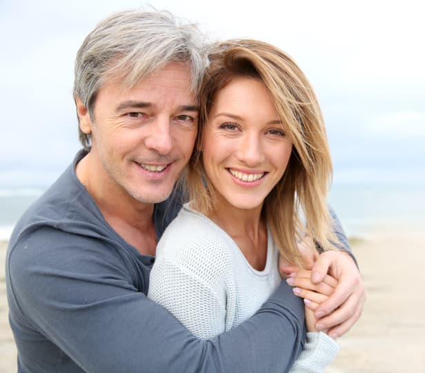 happy middle aged couple at the beach