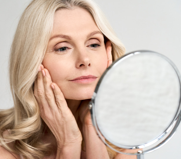 woman looking in mirror