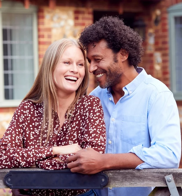Couple with great skin outside their house