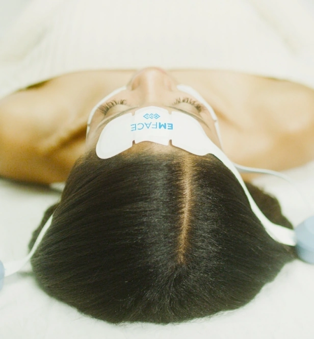 Woman wearing the emface applicators
