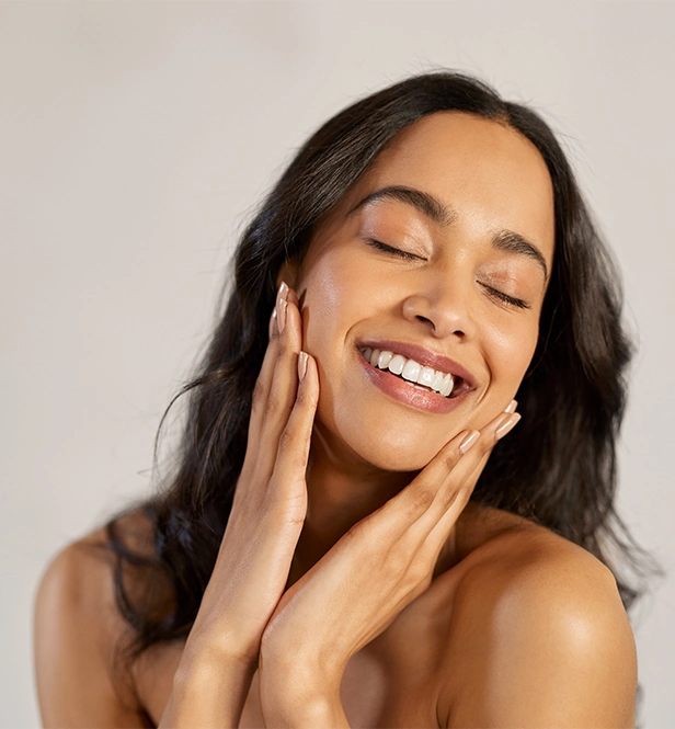 Woman touching refreshed skin after treatment