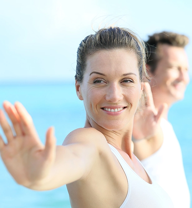happy mature couple doing yoga stretches