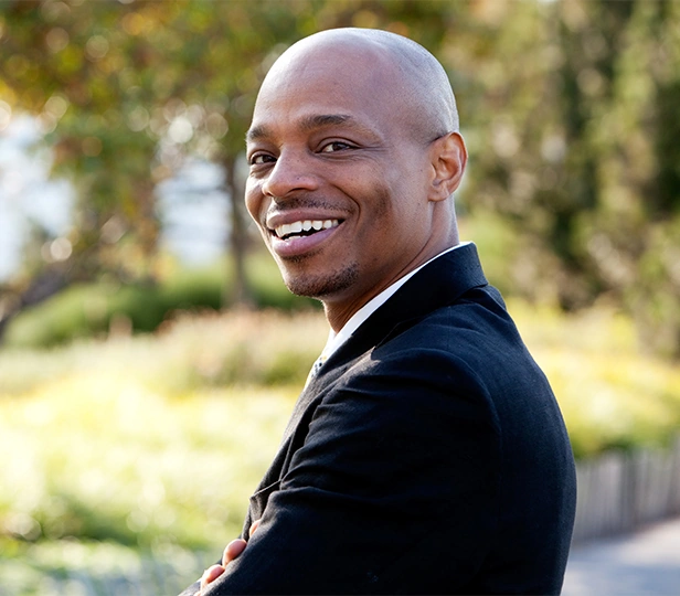 attractive bald businessman smiling outdoors